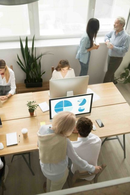 Senior and young employees work in office together, older executives training colleagues, corporate staff discussing ideas collaborating in coworking, team people group teamwork, top vertical view